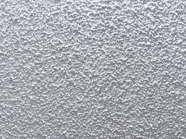 A close-up of a textured popcorn ceiling commonly found in older homes.